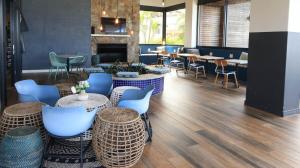 a restaurant with blue chairs and tables and a fireplace at Ballito Hill's Serenity Suite in Ballito