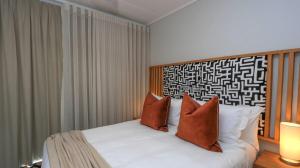a bedroom with a white bed with two pillows at Ballito Hill's Serenity Suite in Ballito +24 photos