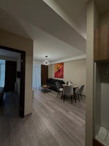 a living room with a table and chairs and a couch at Relax Apartments in Crystal Residence Bakuriani in Bakuriani