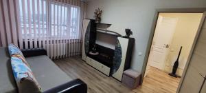a living room with a tv and a couch at Homestay Ezerkrasts in Liepāja