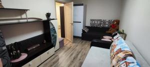 a living room with a couch and a teddy bear at Homestay Ezerkrasts in Liepāja