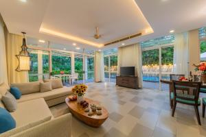 a living room with a couch and a table at Diamond sea villa in Danang
