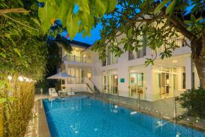 an exterior view of a villa with a swimming pool at Diamond sea villa in Danang