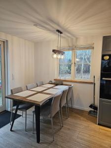 a dining room table and chairs in a room at NordNest in Frederiksværk