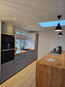 a kitchen with stainless steel appliances and a skylight at NordNest in Frederiksværk