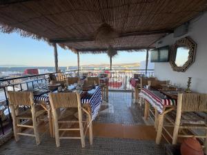 a restaurant with a table and chairs on a balcony at Riad Qasr El Medina in Tangier