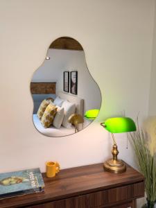 a mirror on a wall above a wooden table at ALP'INN Les Gets in Les Gets