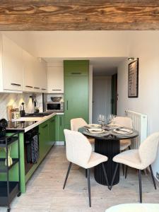a kitchen and dining room with a table and chairs at ALP'INN Les Gets in Les Gets +10 photos