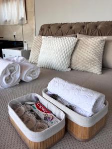 two containers of towels sitting on a bed at Sítio Volta Fria in Pedra Menina +18 photos