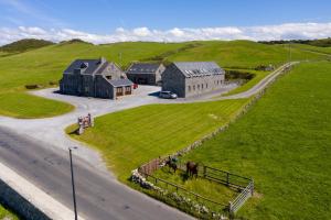 an aerial view of a house with a horse in the grass at Apartment 1 in Doolin