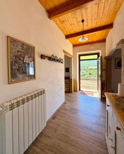 a kitchen with wooden ceilings and a wooden floor at Casa Vacanze LA CIMINEA in Erula