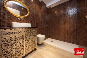 a bathroom with a sink and a toilet and a mirror at Domus Halo D in Pamplona