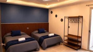 a bedroom with two beds and a mirror at Hotel Boutique Piedra & Altura in San Juan Teotihuacán +24 photos