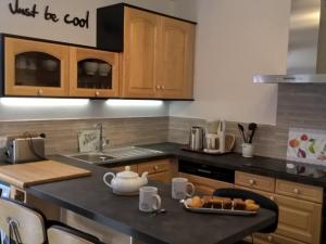 a kitchen with a counter top with a tea pot on it at La Sabotiere in Pluméliau