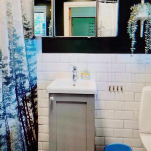 a bathroom with a white sink and a mirror at Bright, fully equipped property in Örebro in Örebro