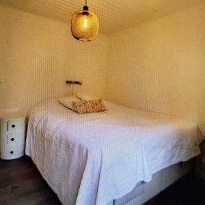 a bedroom with a white bed in a room at Bright, fully equipped property in Örebro in Örebro