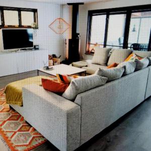 a living room with a couch and a tv at Bright, fully equipped property in Örebro in Örebro
