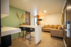 a kitchen and living room with a couch and a table at Hotel Omenia in Tequisquiapan +22 photos