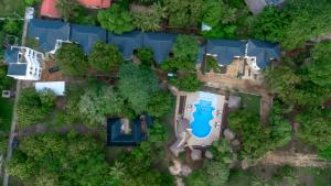 an overhead view of a house with a swimming pool and trees at Musituni Luxury Villas in Diani Beach +9 photos