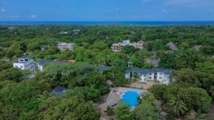 an aerial view of a mansion with a pool and trees at Musituni Luxury Villas in Diani Beach