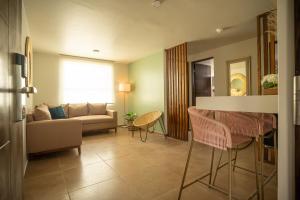 a living room with a couch and a table and chairs at Hotel Omenia in Tequisquiapan