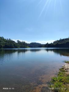 a view of a lake with trees in the background at Casa dos bons encontros in Santa Isabel