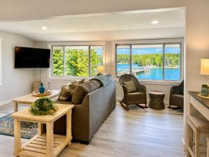 a living room with a couch and a tv at Oceanfront Cottage on Private Island in Milbridge