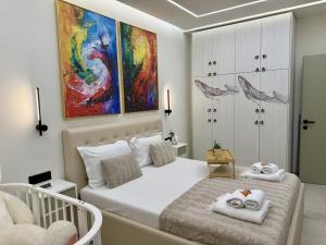 a bedroom with a bed with towels on it at Marevista Escape in Golem +70 photos