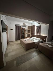 a large bedroom with two beds and a mirror at Kiki by the sea Villa in Paralia Katerinis