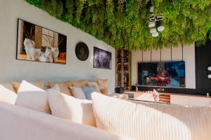 a living room with white couches at Residence Cottages in Morogoro