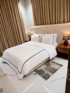 a bedroom with a large white bed and curtains at Residence Cottages in Morogoro +28 photos