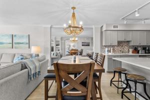 a kitchen and living room with a table and a couch at Litchfield Beach & Golf Resort in Pawleys Island