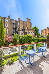 a balcony with tables and chairs and buildings at Number 31 in Dublin