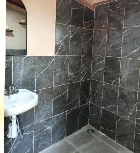 a bathroom with a sink and a mirror at San Pedro Atmatla Zacatlan Cabins in Zacatlán