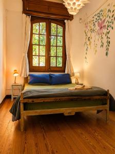 a bedroom with a bed with a window at Youki Haus Hostel in Montevideo
