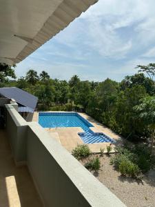 a view of a swimming pool from the balcony of a house at Casa Finca pasadia cerete in Cereté