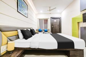 a bedroom with a large bed in a room at Super Townhouse Dewas City Formerly Utsav in Dewās