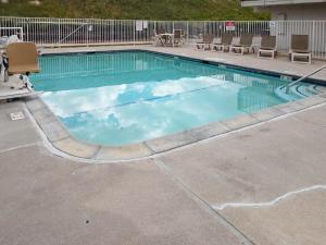 a large swimming pool with blue water at Motel 6 Cheyenne, WY in Cheyenne
