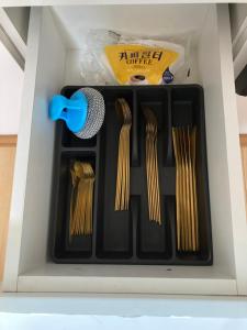 a drawer with ties and a microphone in it at Newly Renovated Japandi 1BR Near Shangri-La in Ulaanbaatar