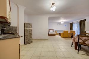 a kitchen and living room with a table and chairs at Lagoonia Sun Hotel in Fethiye