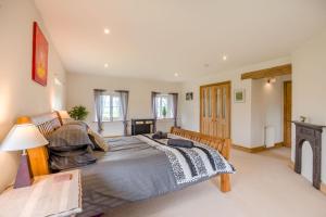 a large bedroom with a large bed and a fireplace at 7 Bed in Langbar oc-d34075 in Middleton