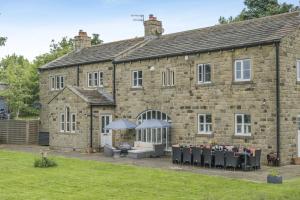an old stone building with tables in front of it at 7 Bed in Langbar oc-d34075 in Middleton