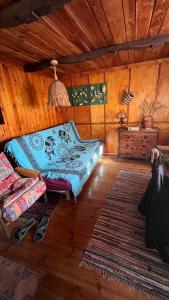 a bedroom with a bed in a wooden room at Dacza Warmińska, domek letniskowy na jeziorem in Sząbruk +8 photos