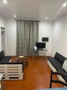 a living room with a couch and a table at Old house in Tarrafal