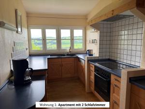 a kitchen with a sink and a stove at Schads Bergheimat in Wertach +17 photos