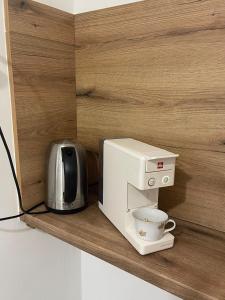 a coffee maker sitting on a shelf with a coffee cup at Holiday House Bribir in Bribir