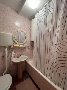 a bathroom with a sink and a shower curtain at Holiday House Bribir in Bribir