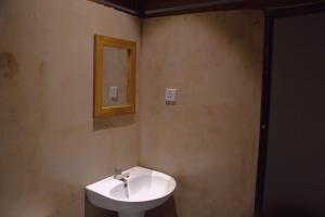 a bathroom with a sink and a mirror on the wall at Arugambay Wave House in Arugam Bay