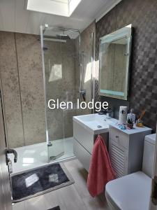 a bathroom with a shower and a sink and a mirror at Glen lodge Craig Tara in Ayr +8 photos