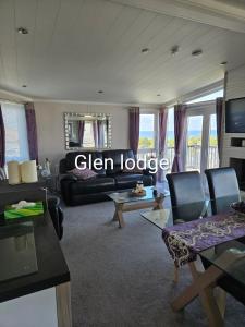 a living room with a couch and a table at Glen lodge Craig Tara in Ayr